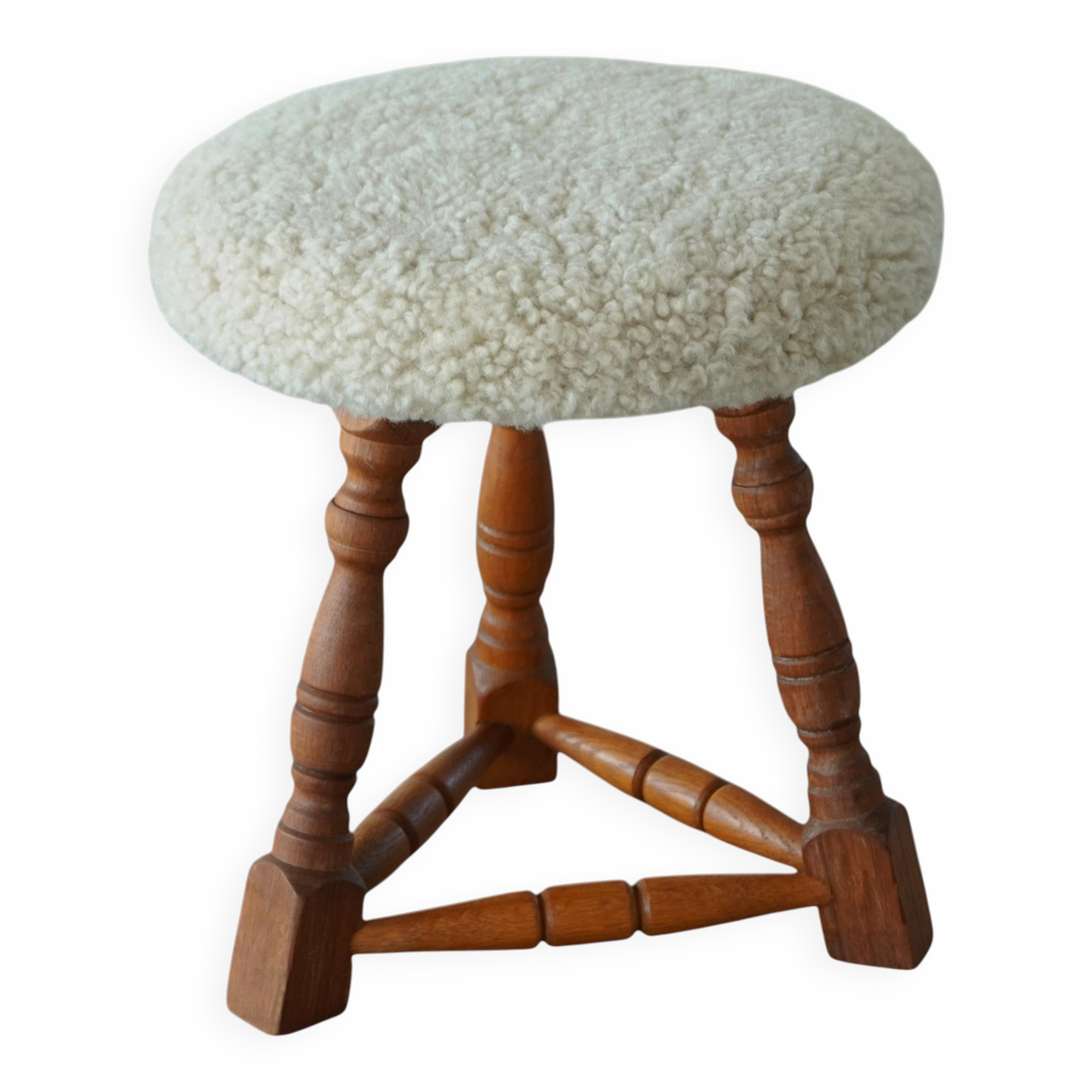Modern Danish stool, with three oak legs featuring turned feet and a lambswool seat, 1950s.