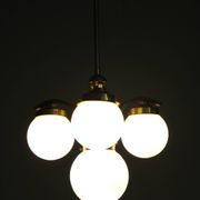 1930s Czechoslovak Art Deco brass chandelier with four opaline glass globes