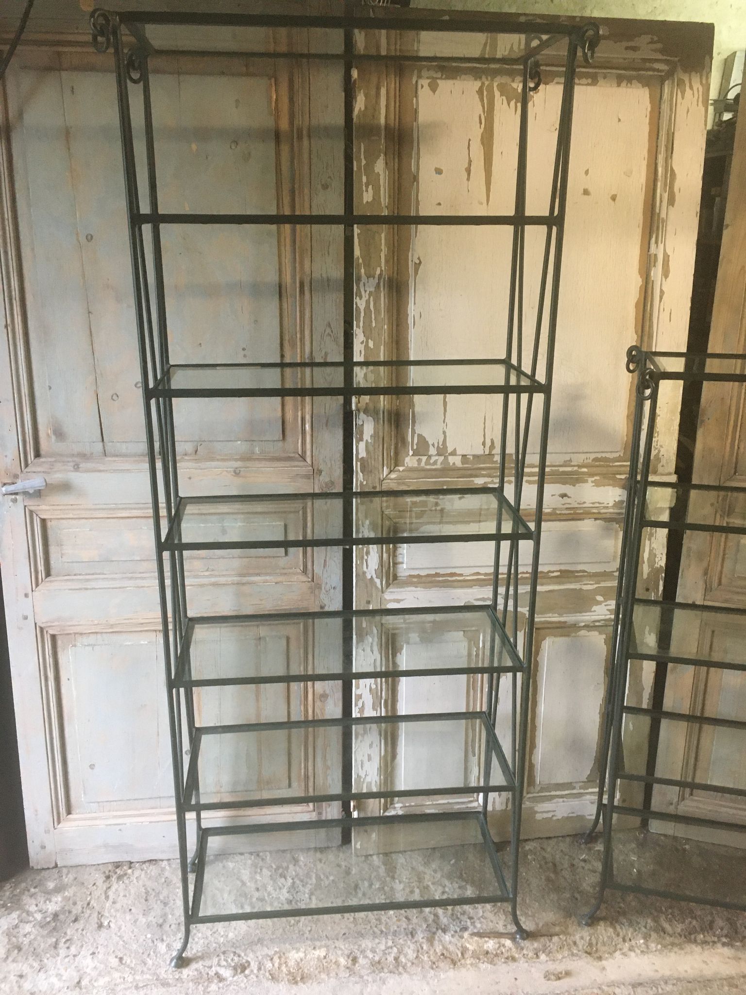 Pair of wrought iron and glass bookshelf shelves.