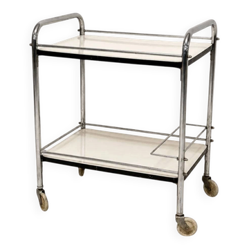 Vintage chrome bar cart with white Formica shelves.