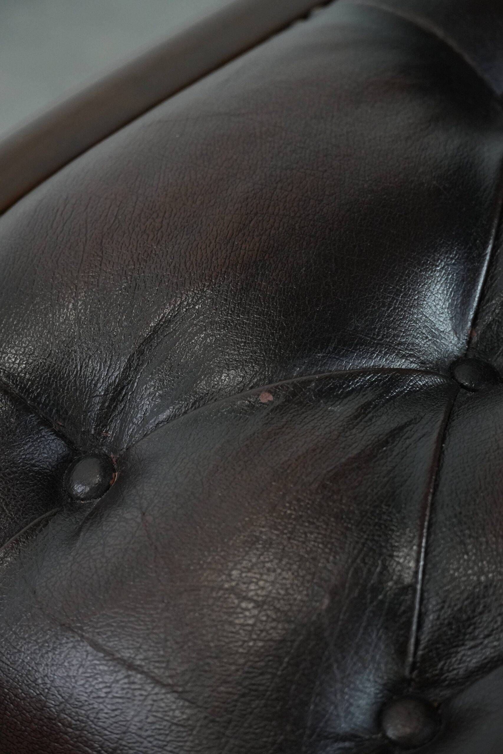Chesterfield office chair in English style made of cow leather and wood.
