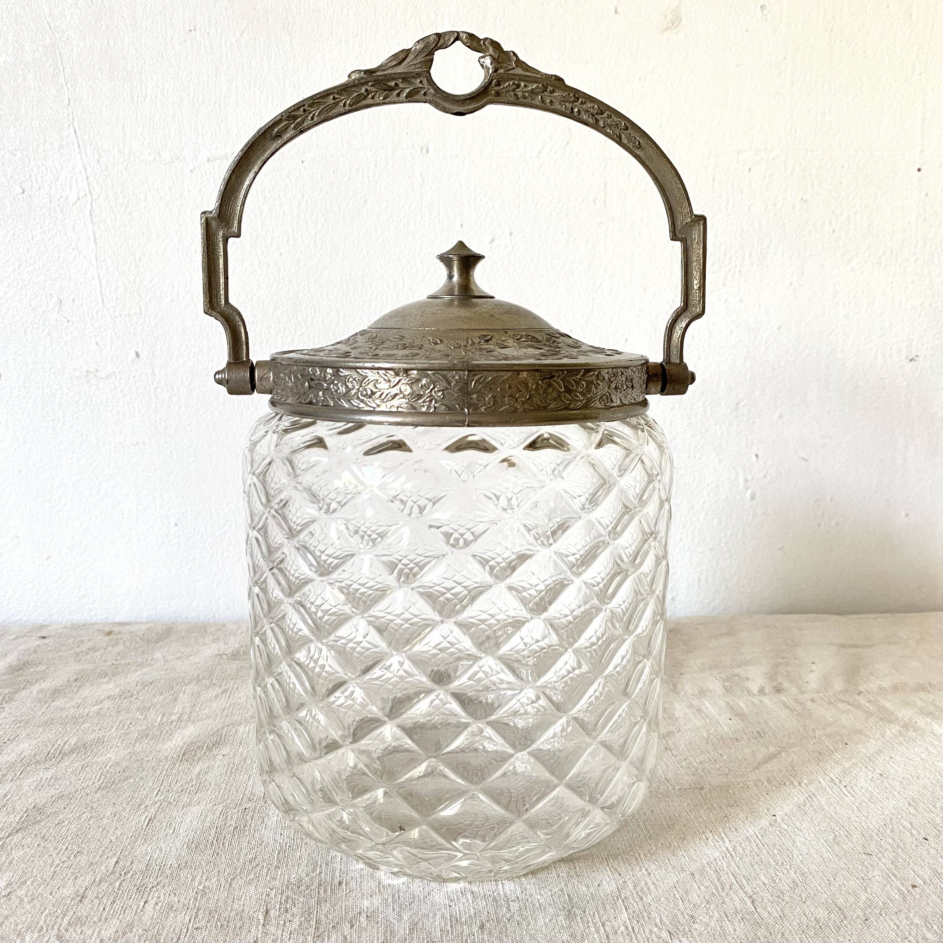 Old biscuit bucket in glass and metal