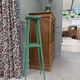 Vintage wooden stool with green patina.