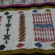 Handmade Berber kilim rug with multicoloured tribal motifs.