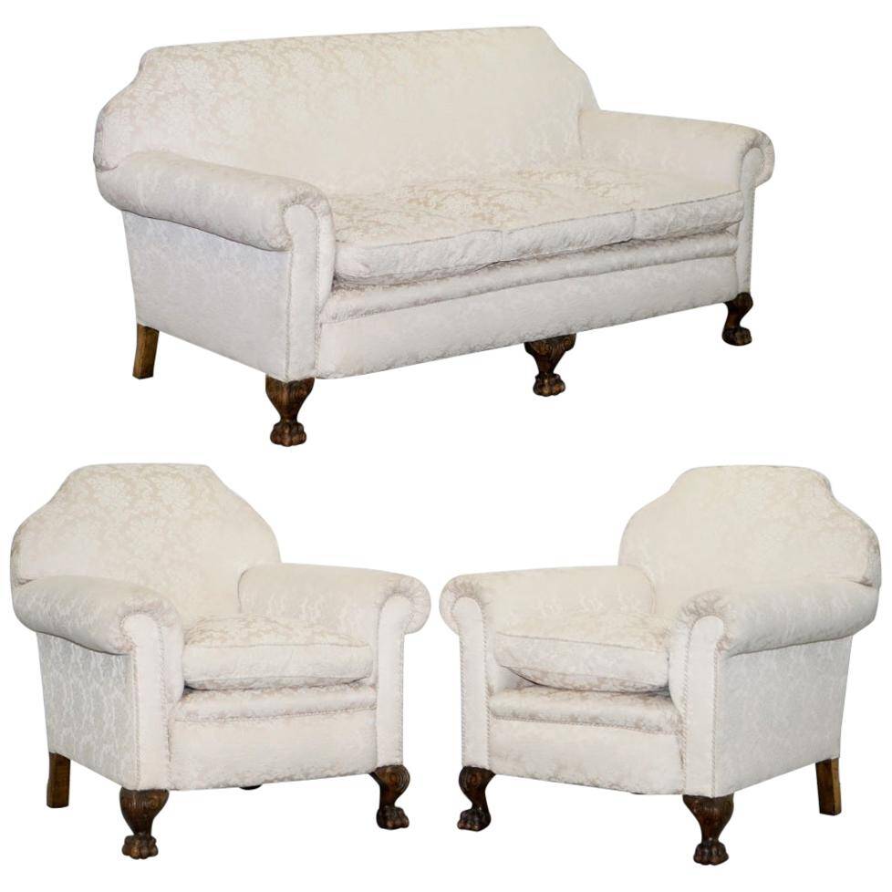 Victorian suite in damask, walnut frame, legs carved in lion's paw.