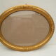 Large old oval gilded wooden frame and stucco decorations