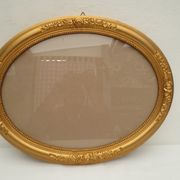 Large old oval gilded wooden frame and stucco decorations