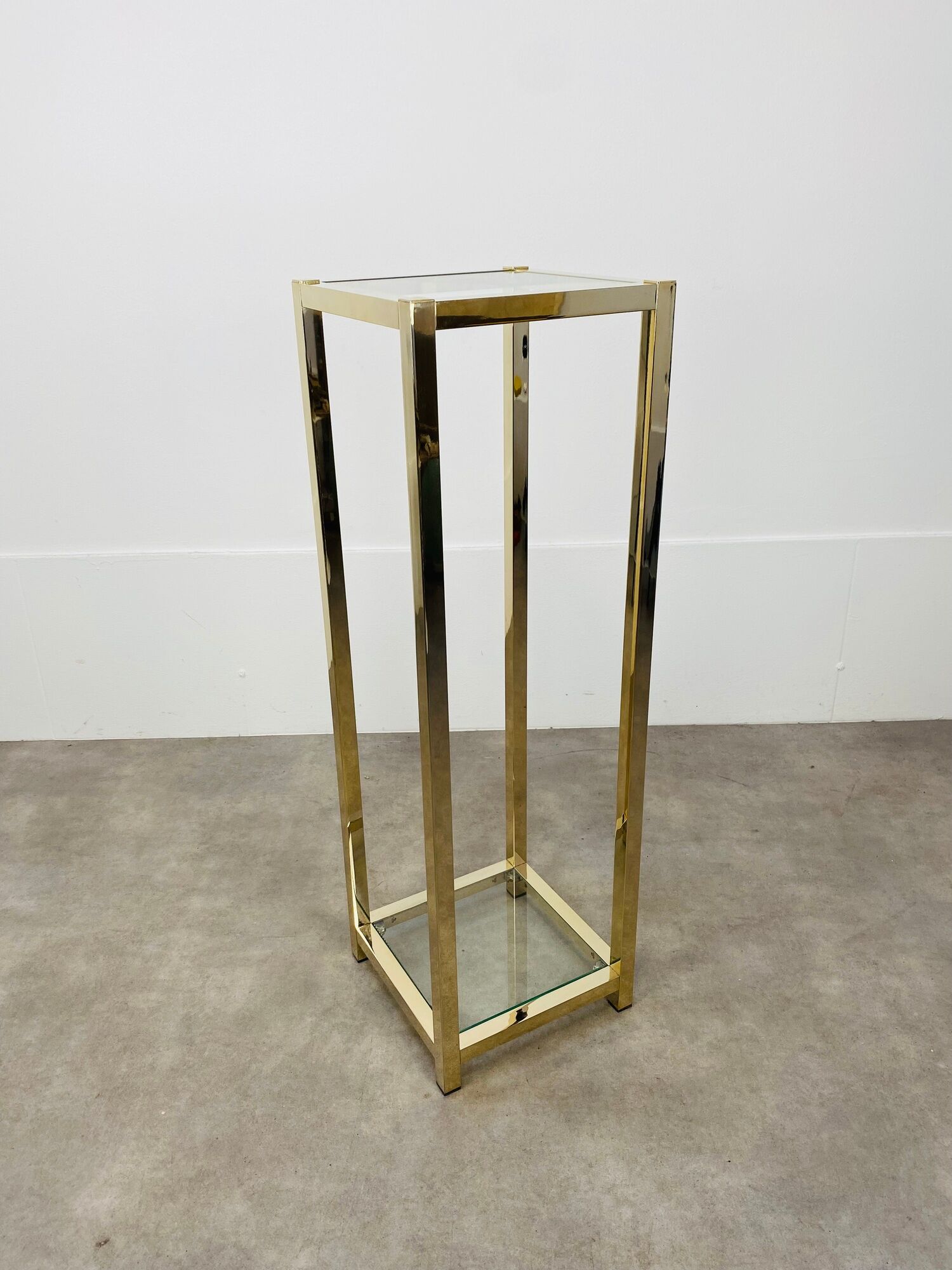 Gilded metal fifth wheel column and Hollywood Regency style glass 70s