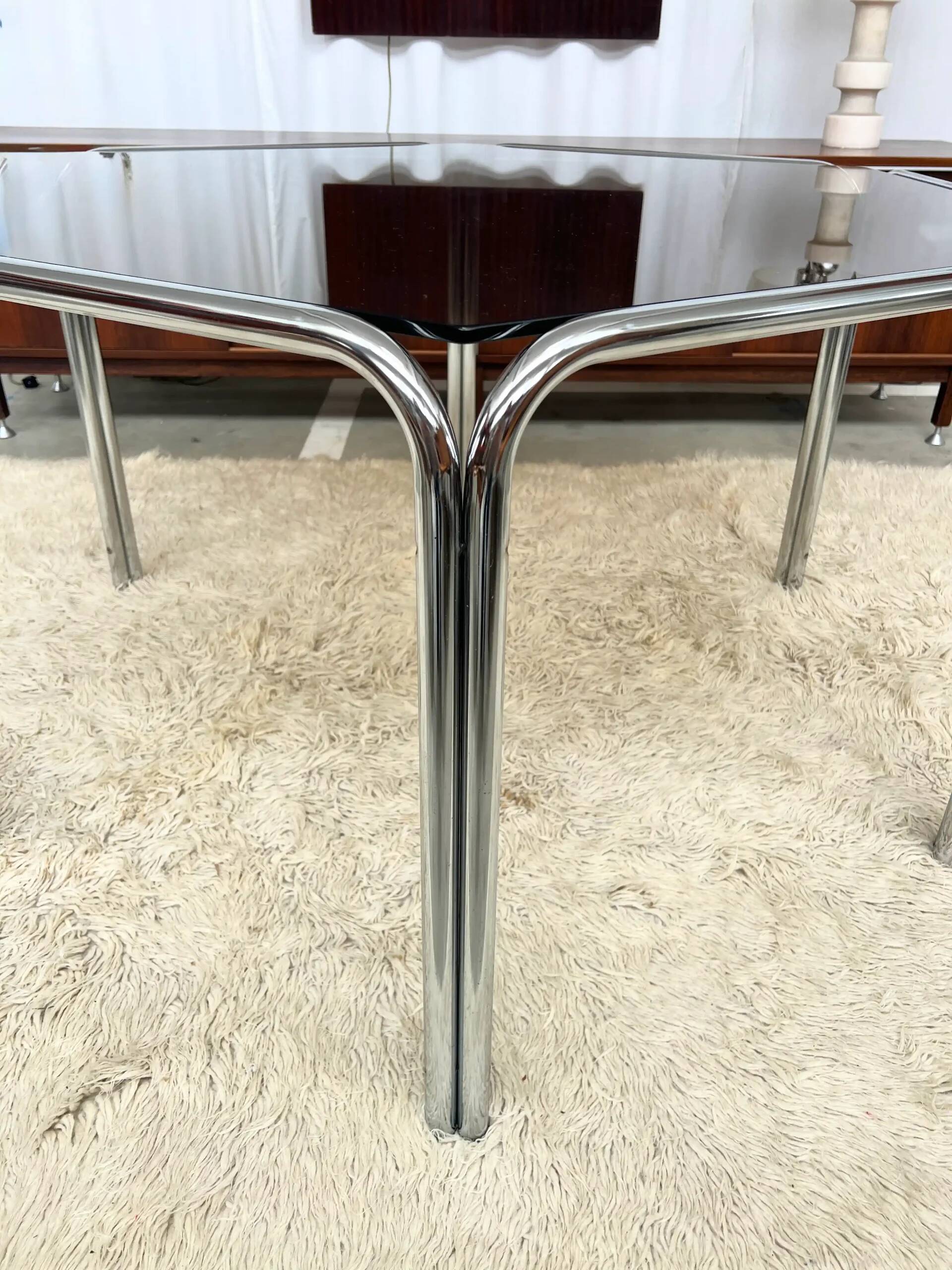 Vintage hexagonal table with smoked glass top and chrome metal structure.