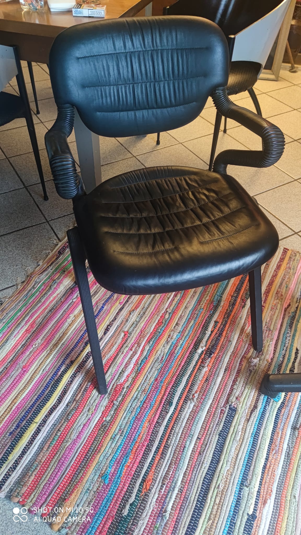 Two black leather armchairs