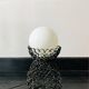 Handcrafted wrought iron lamp with a white opaline globe.