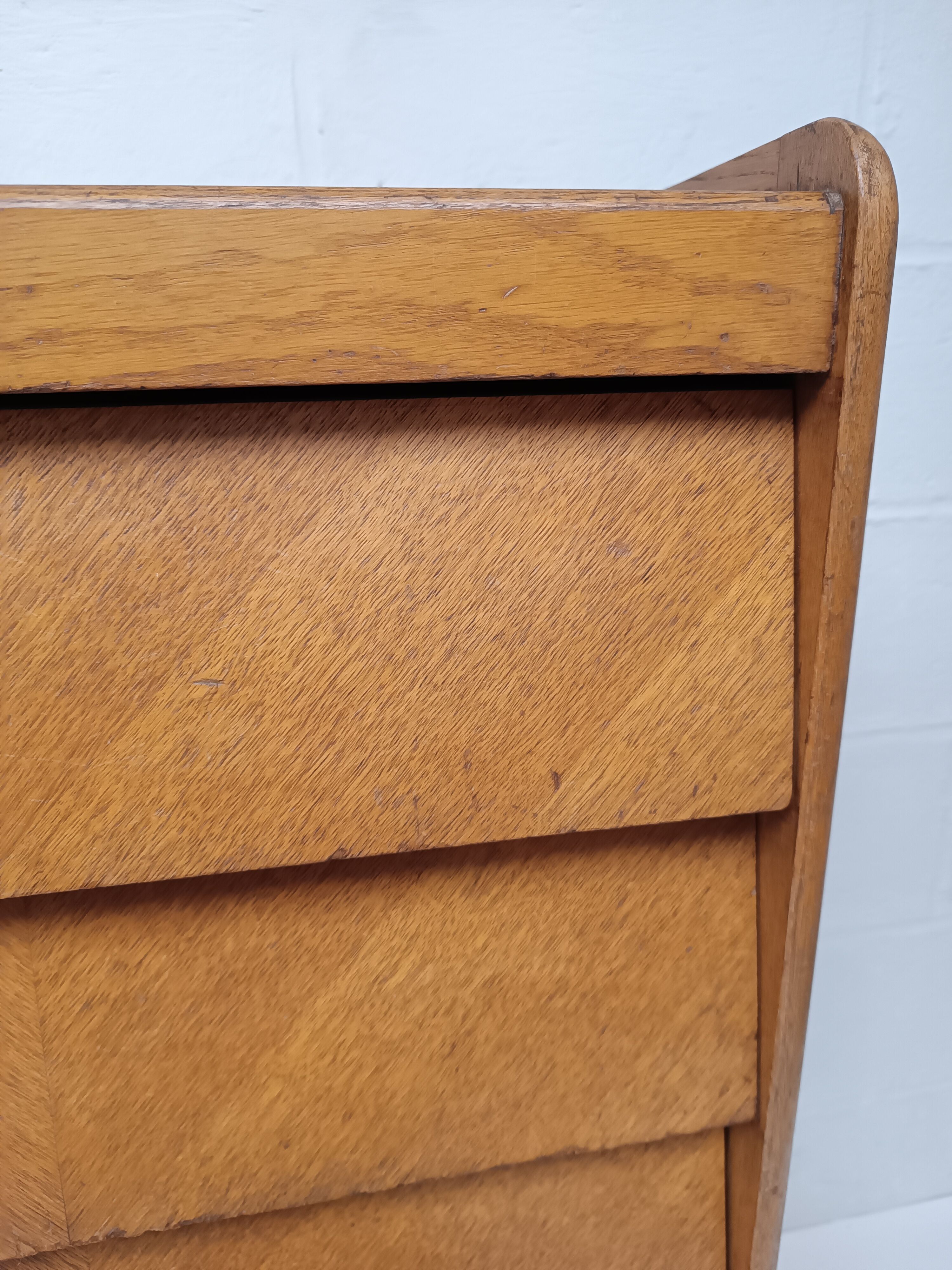 High wooden chest of drawers in the 50s