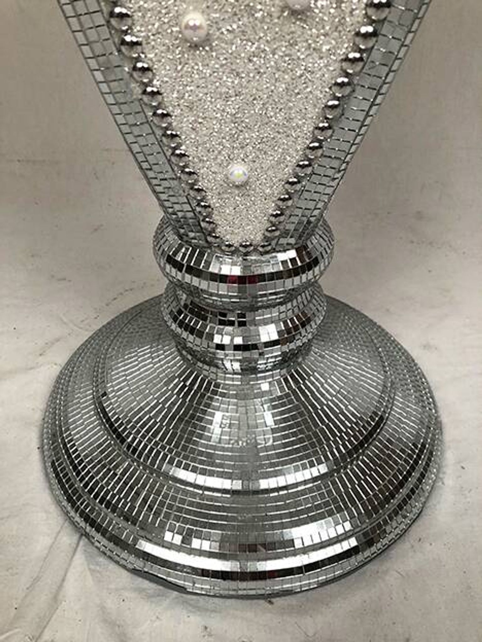 Small wooden pedestal table entirely covered with mirror mosaic