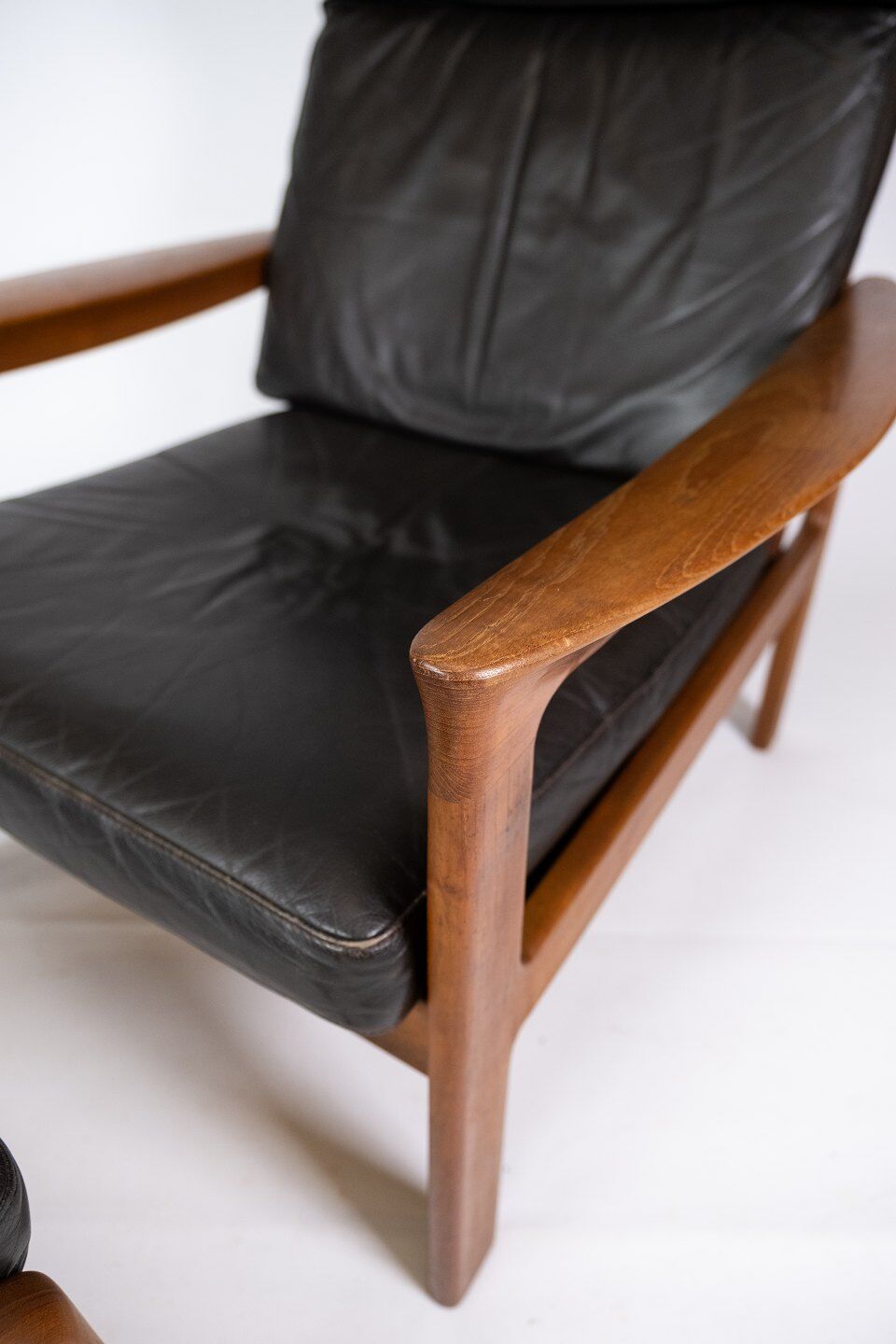 Easy chair with stool in teak upholstered with black leather design Arne Wahl Iversen