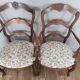 Pair of Provençal armchairs in brown wood and floral fabric.