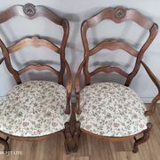 Pair of Provençal armchairs in brown wood and floral fabric.