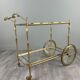 Rolling table cart in gilded brass with two glass shelves, 20th century.
