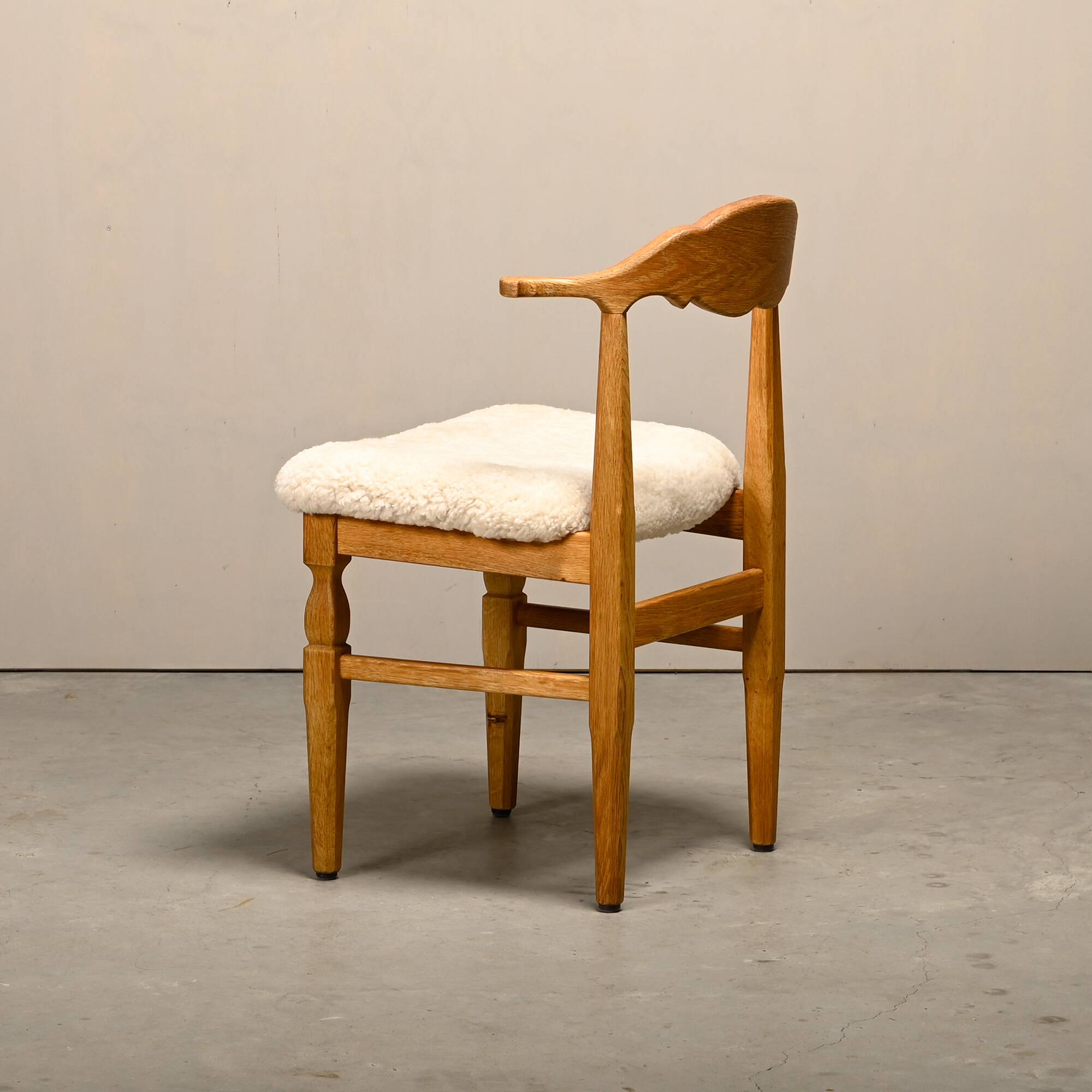 Henning Kjærnulf dining chairs set in Oak and Sheepskin, Denmark, 1960s