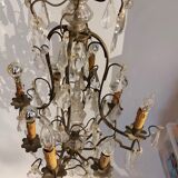 Neoclassical bronze chandelier with 8 lights, tassels and dagger