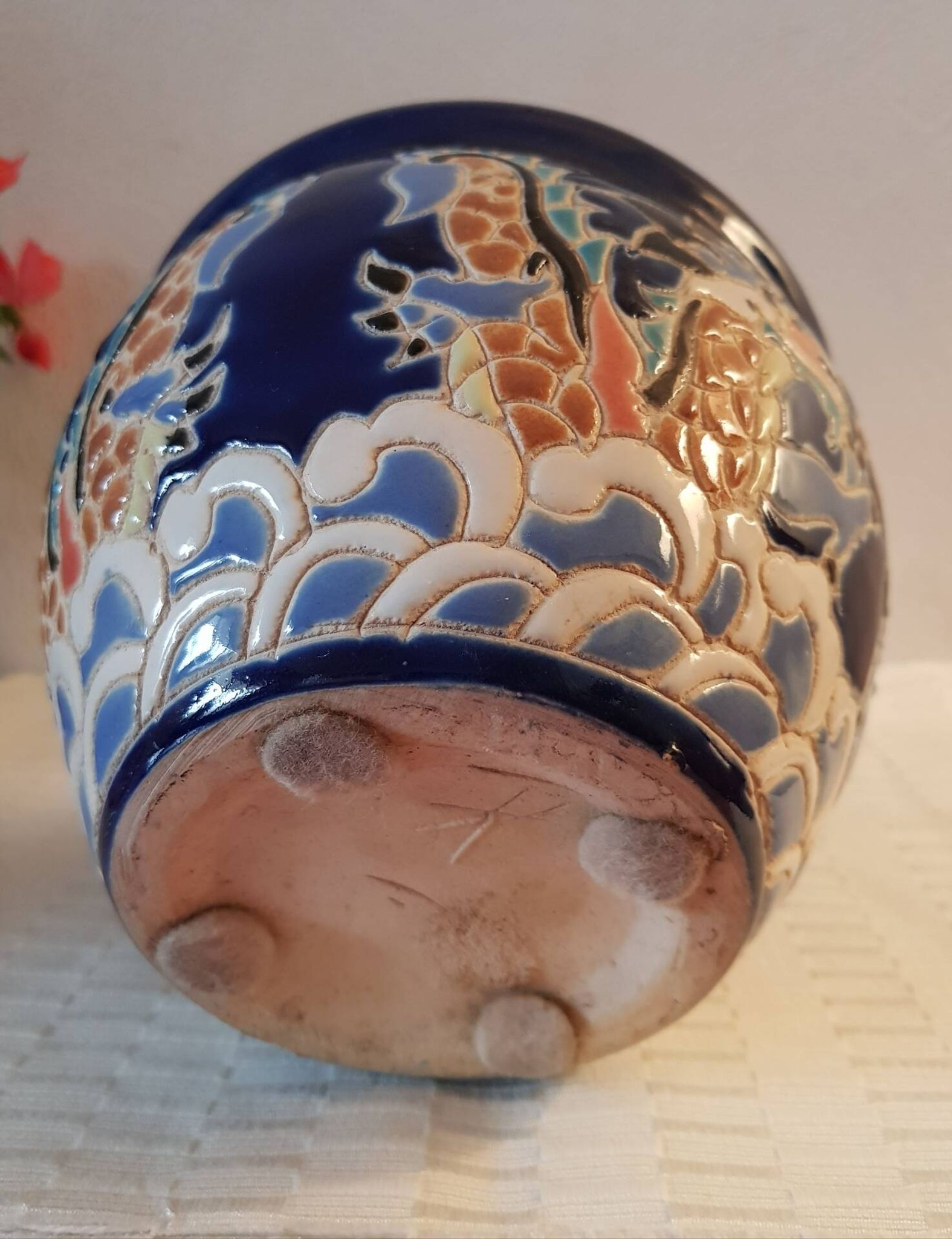 Decorative pot in multicoloured relief glazed ceramic.