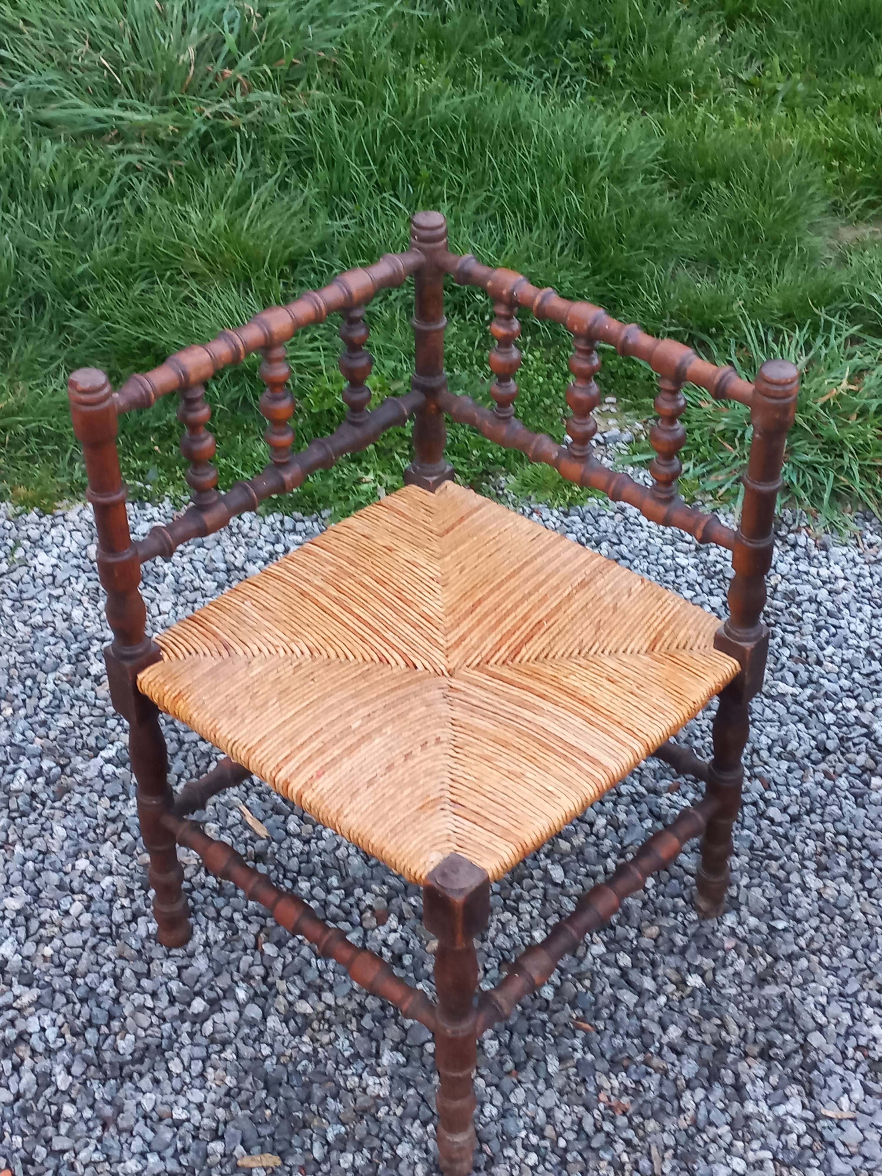 Pair of angled armchairs with turned wood and rush seats from the 1960s.