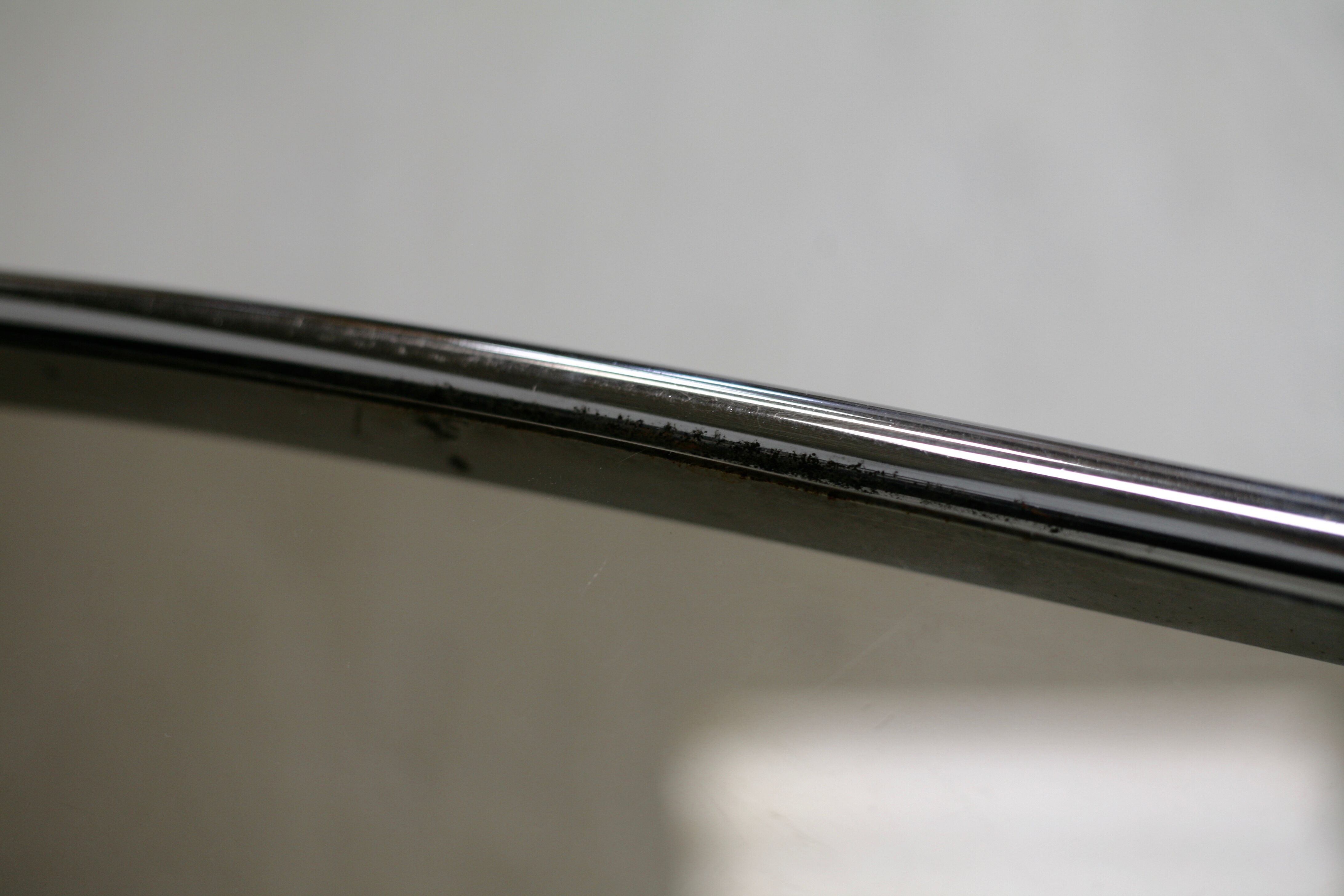 Living table. chrome metal, curved smoked glass slab, france, circa 1970.