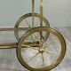 Rolling table cart in gilded brass with two glass shelves, 20th century.