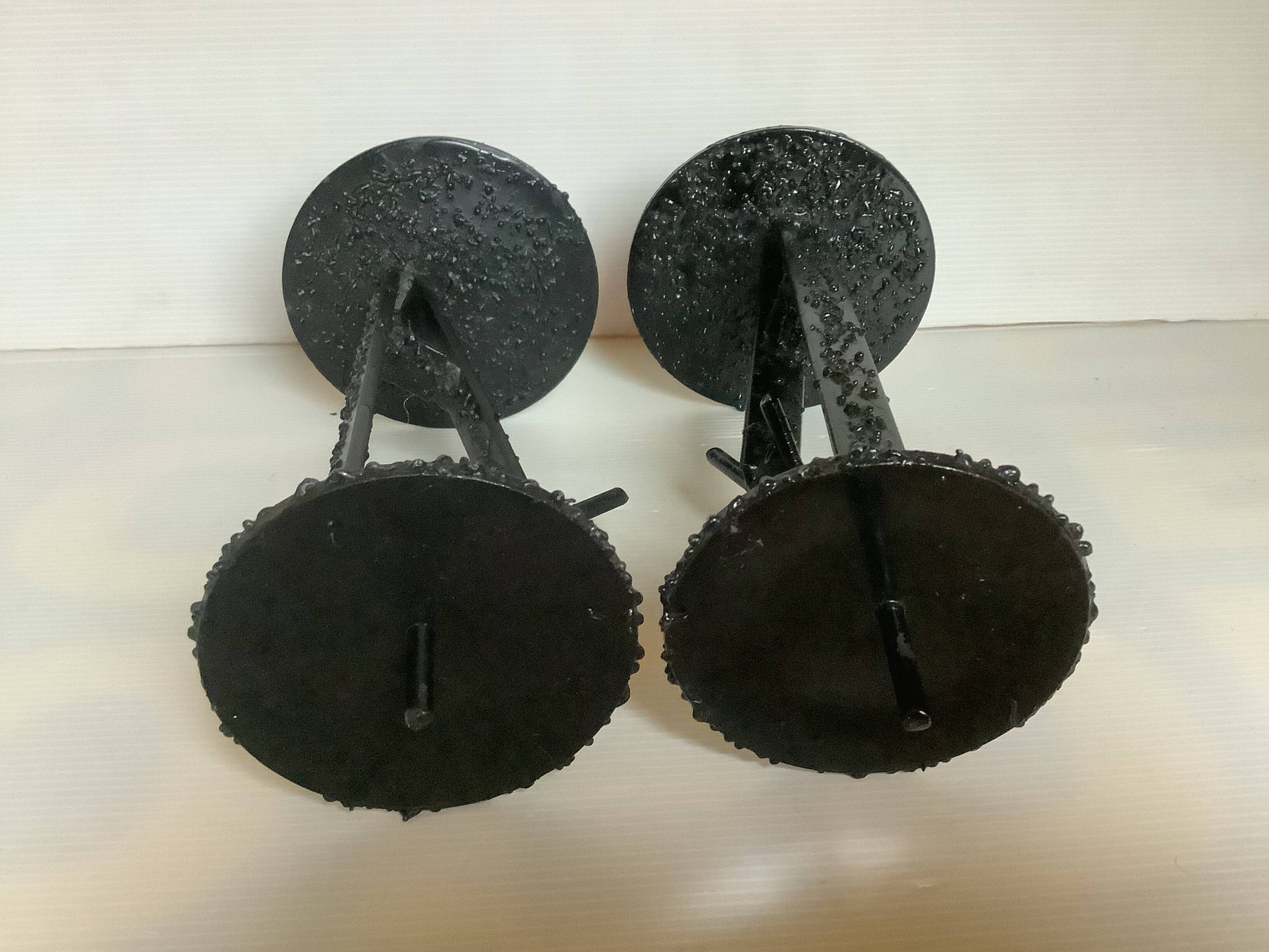 Pair of black metal candlesticks