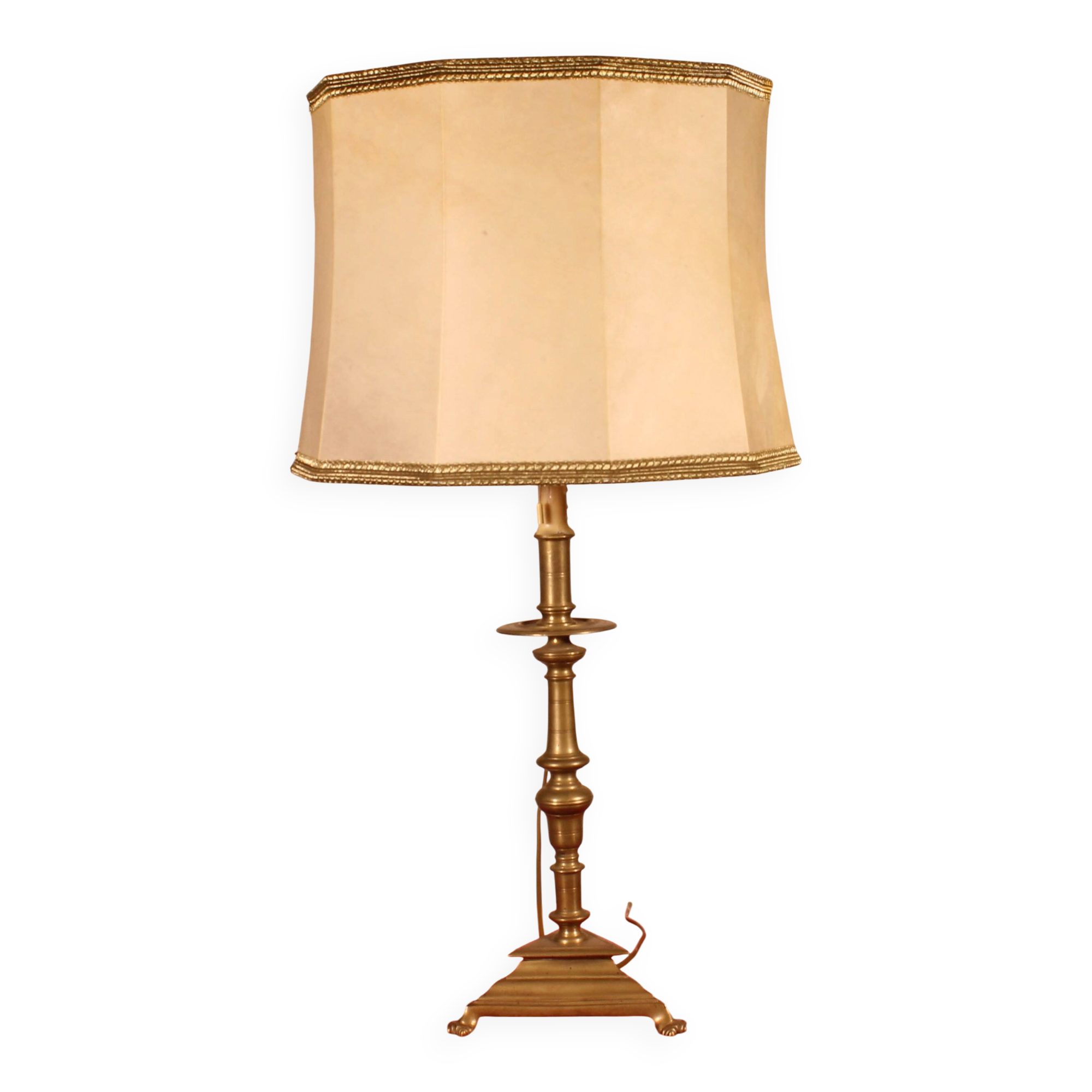 bronze candlestick from the 17th century converted into a lamp with its lampshade