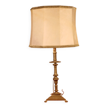 bronze candlestick from the 17th century converted into a lamp with its lampshade