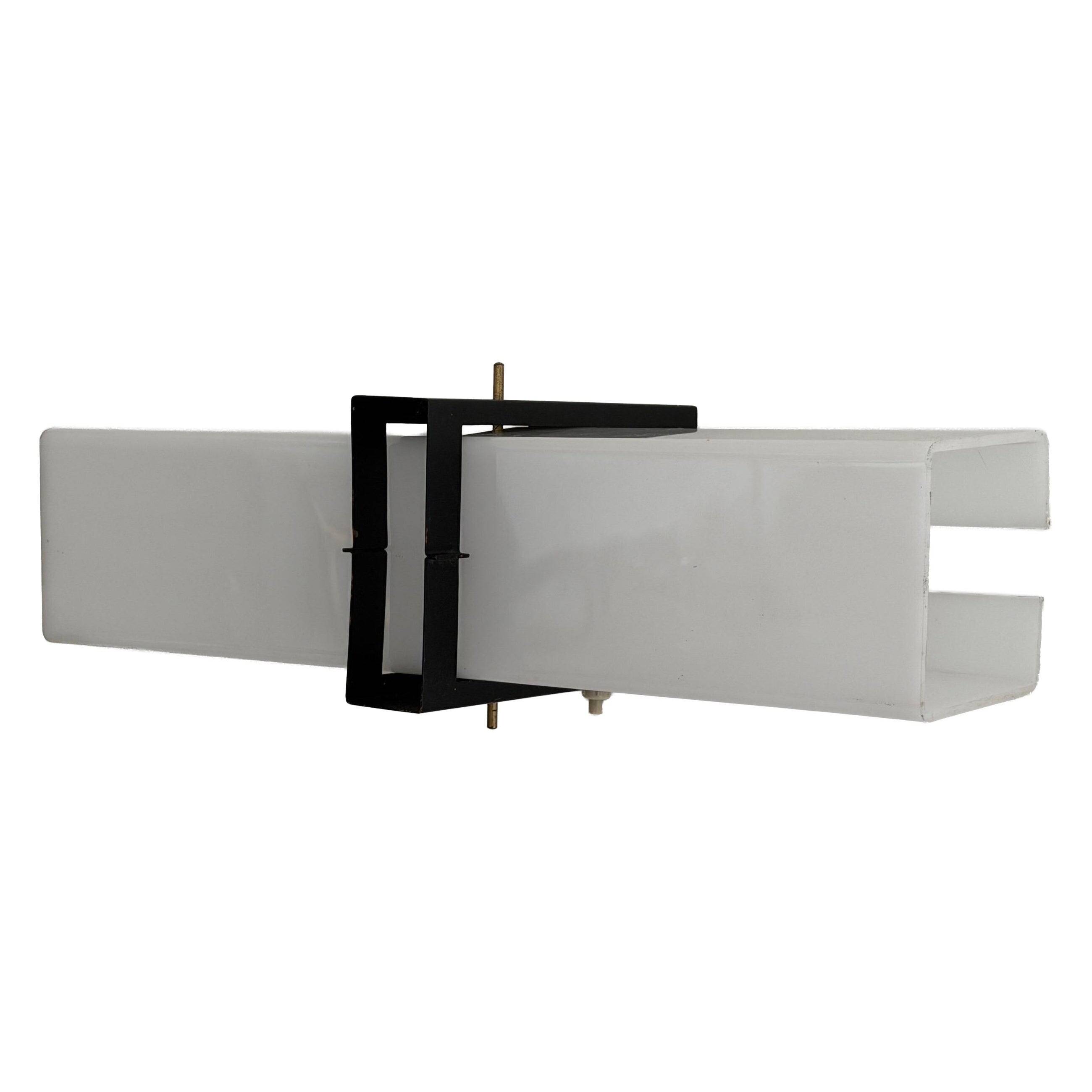 Simple white plexiglass wall light with a black metal frame, 1970s, Germany.