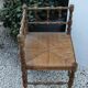 Antique corner chair in wood bamboo style seated in straw