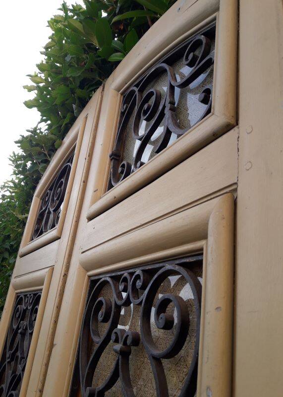 19th century double arched entrance door in oak with grilles and old glass