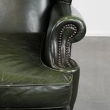 Smooth classic cowhide Chesterfield armchair in a stylish dark green color