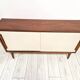 Mid-century teak sideboard with white synthetic doors.