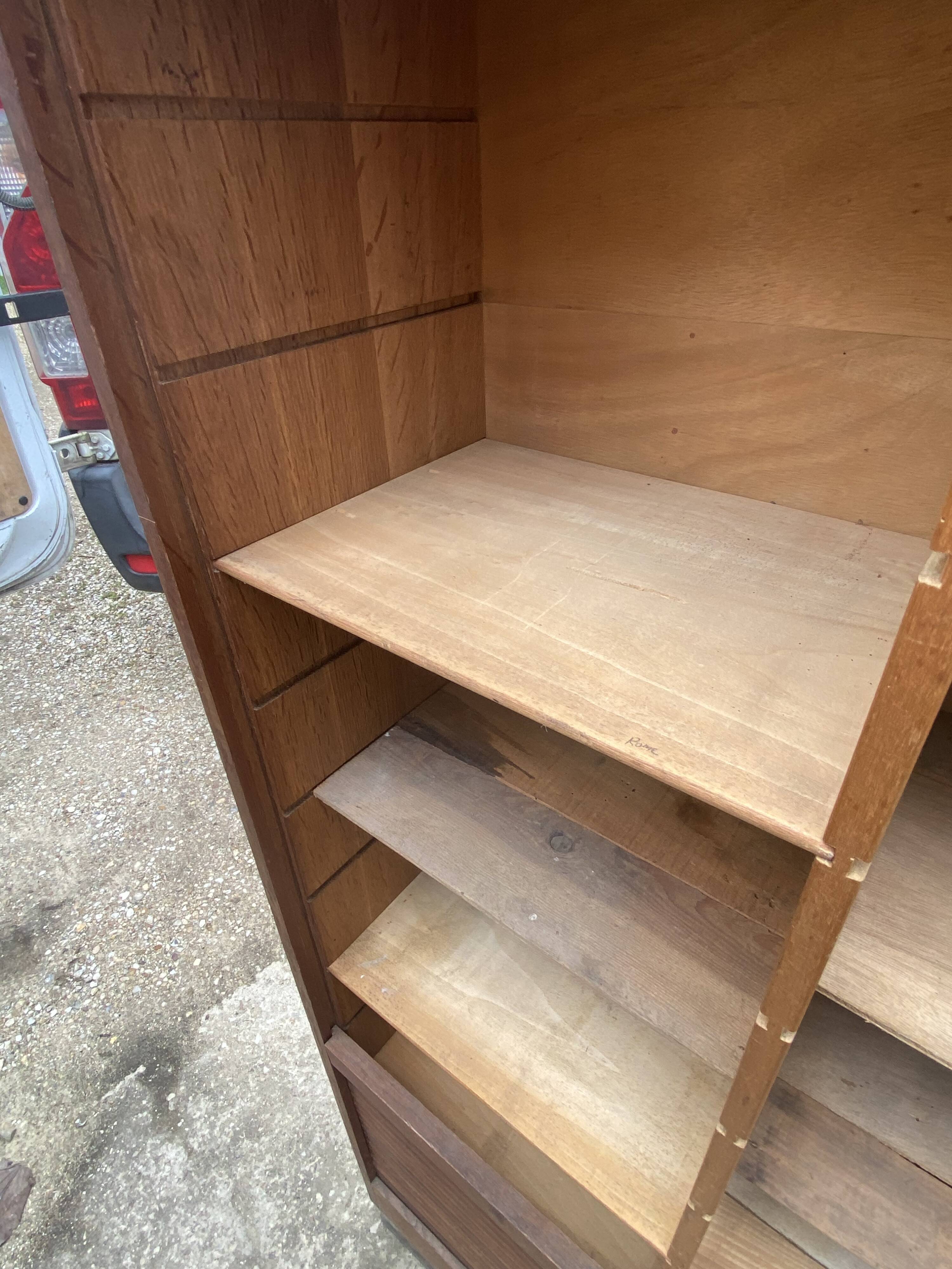 Oak two-column filing cabinet with curtains.