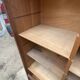 Oak two-column filing cabinet with curtains.