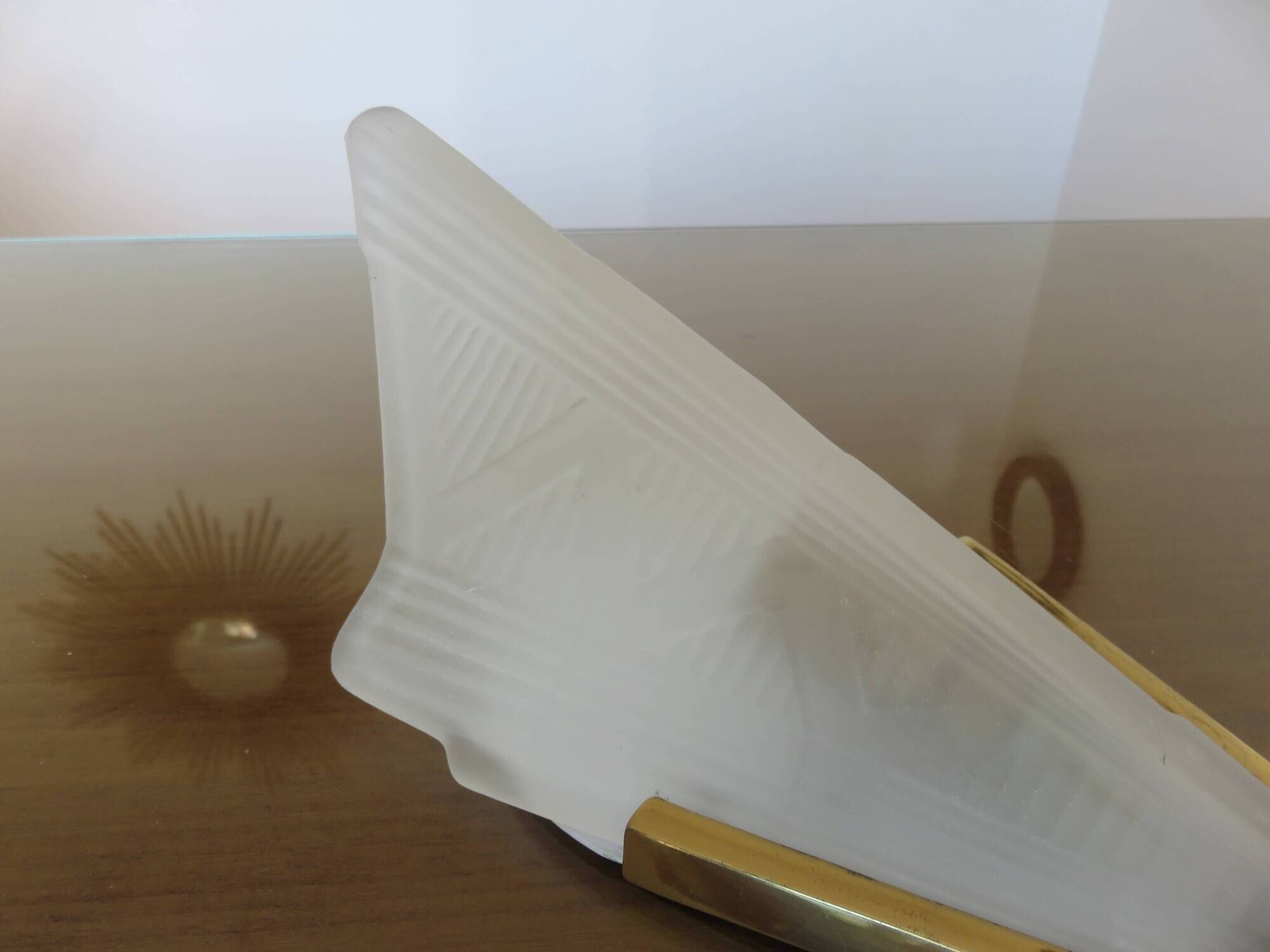 Art Deco wall light in brass and thick frosted glass.