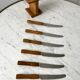 Set of 6 wooden butter knives and their support 70s
