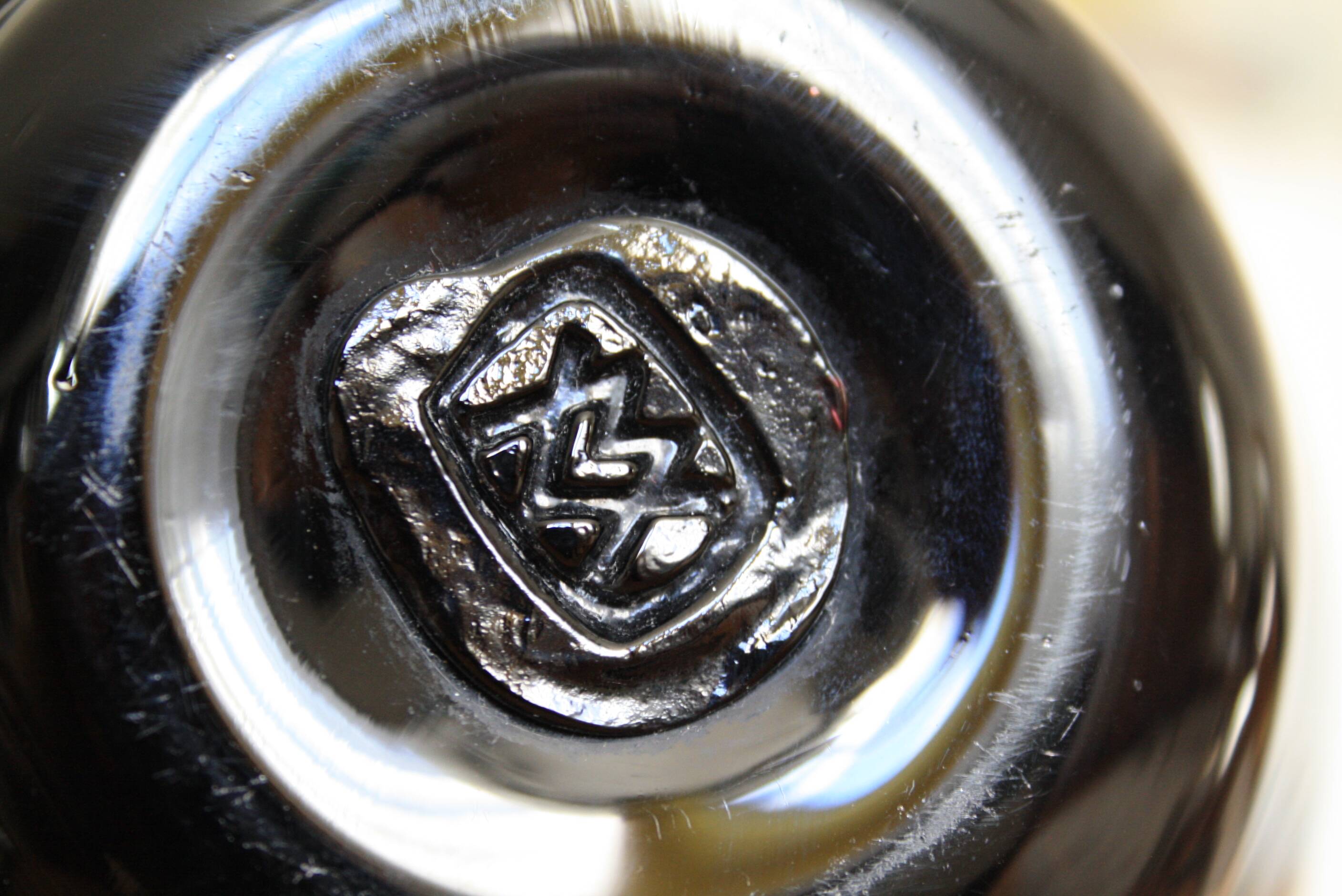 Black vase stamped MV