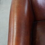 Sheepskin club armchair, correct finishing with decorative nails