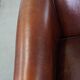 Sheepskin club armchair, correct finishing with decorative nails