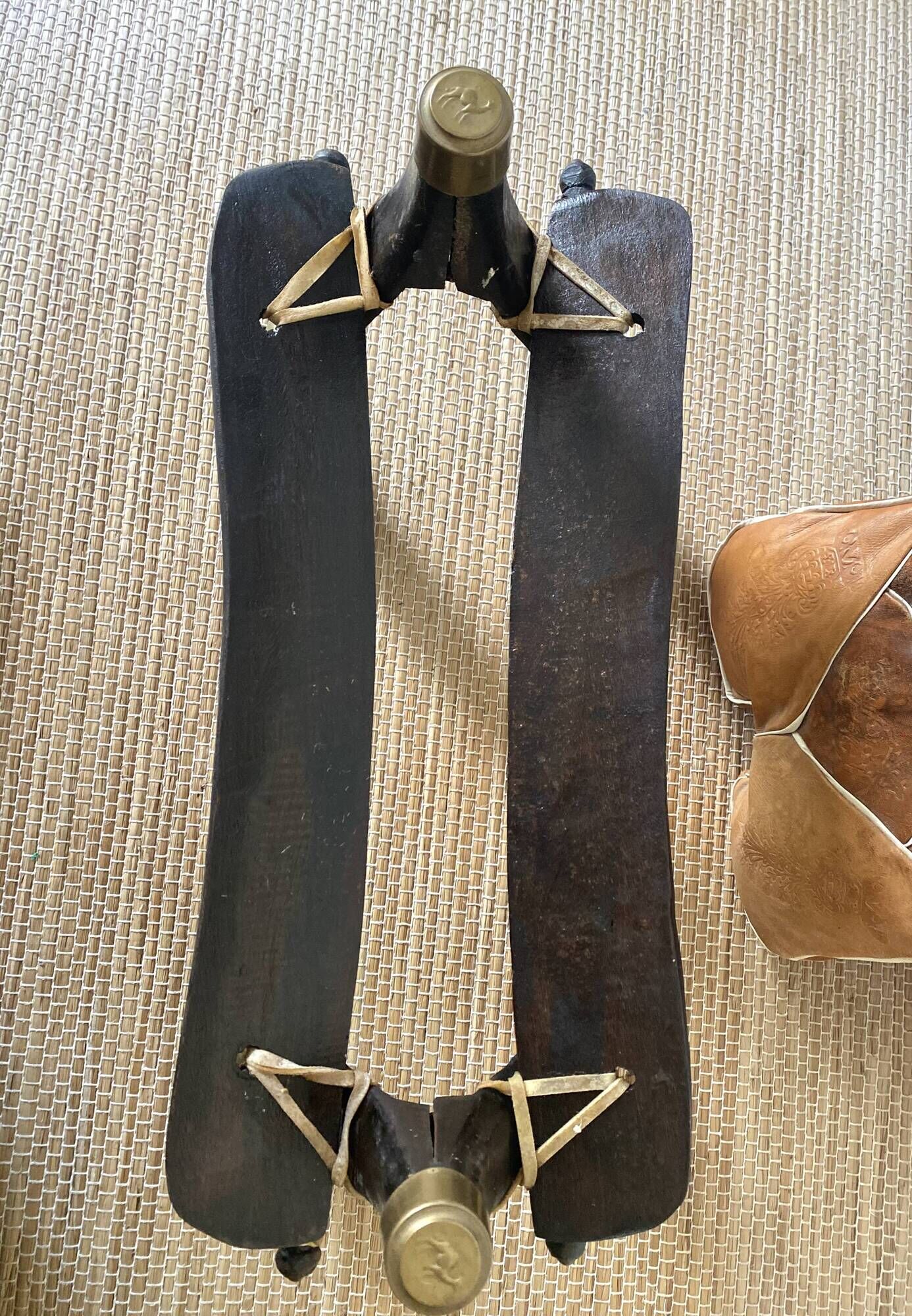 Pair of low Egyptian stools, camel saddles in wood, leather and brass