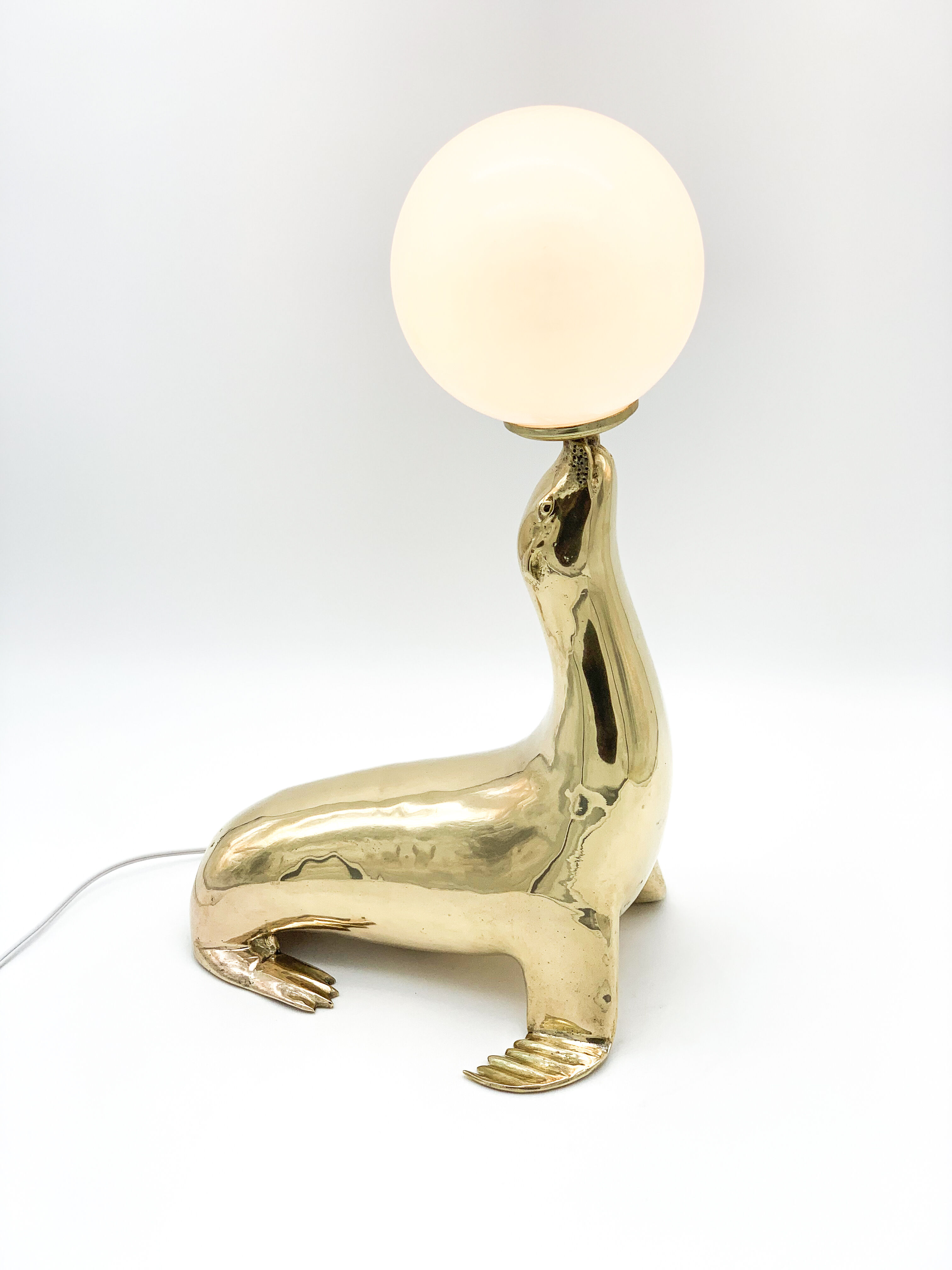 Vintage brass sea lion lamp
