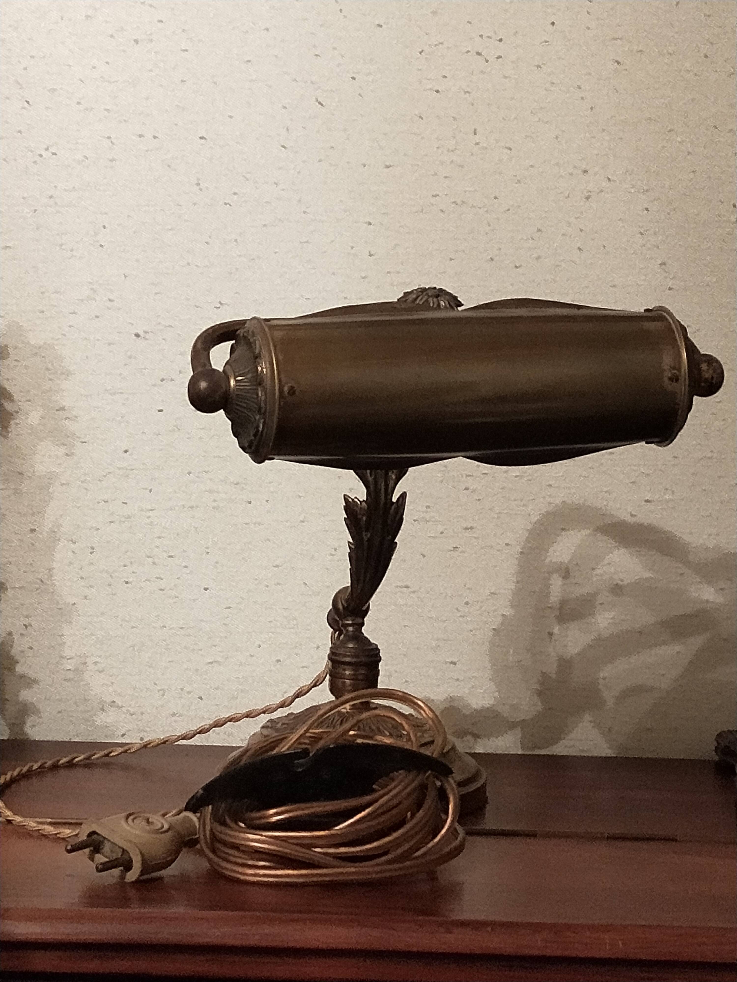 Antique desk piano lamp in chiselled brass.