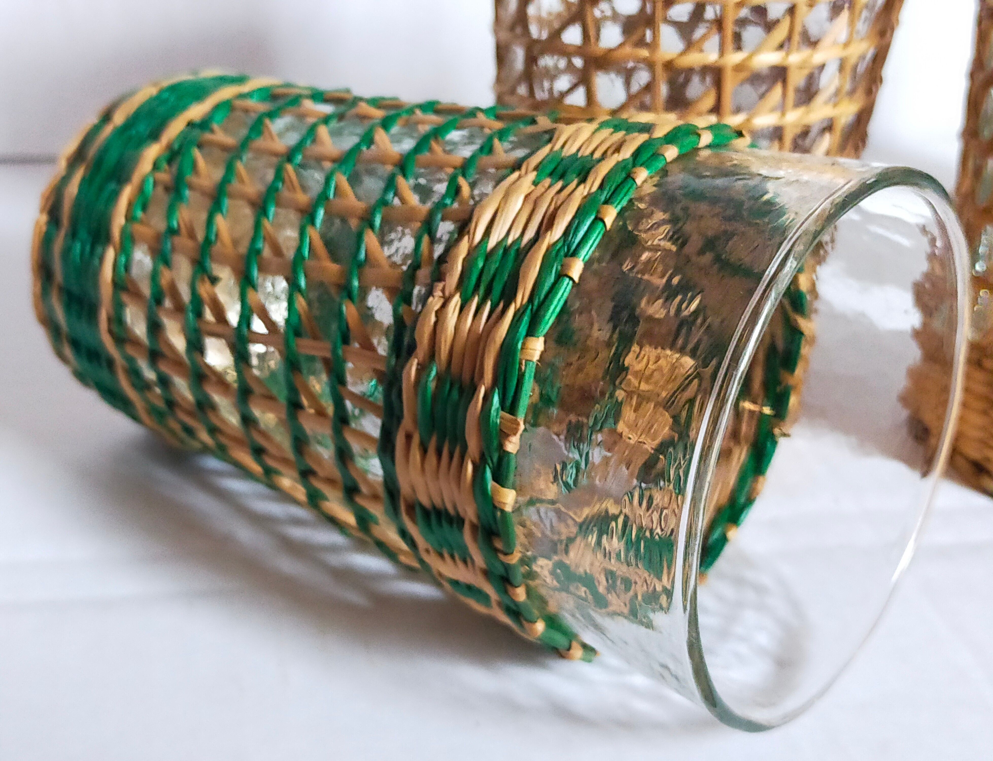 Four long drink glasses in vintage woven rattan cases