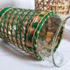 Four long drink glasses in vintage woven rattan cases