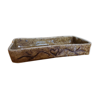 Empty rectangular pocket in sandstone pyrity signed