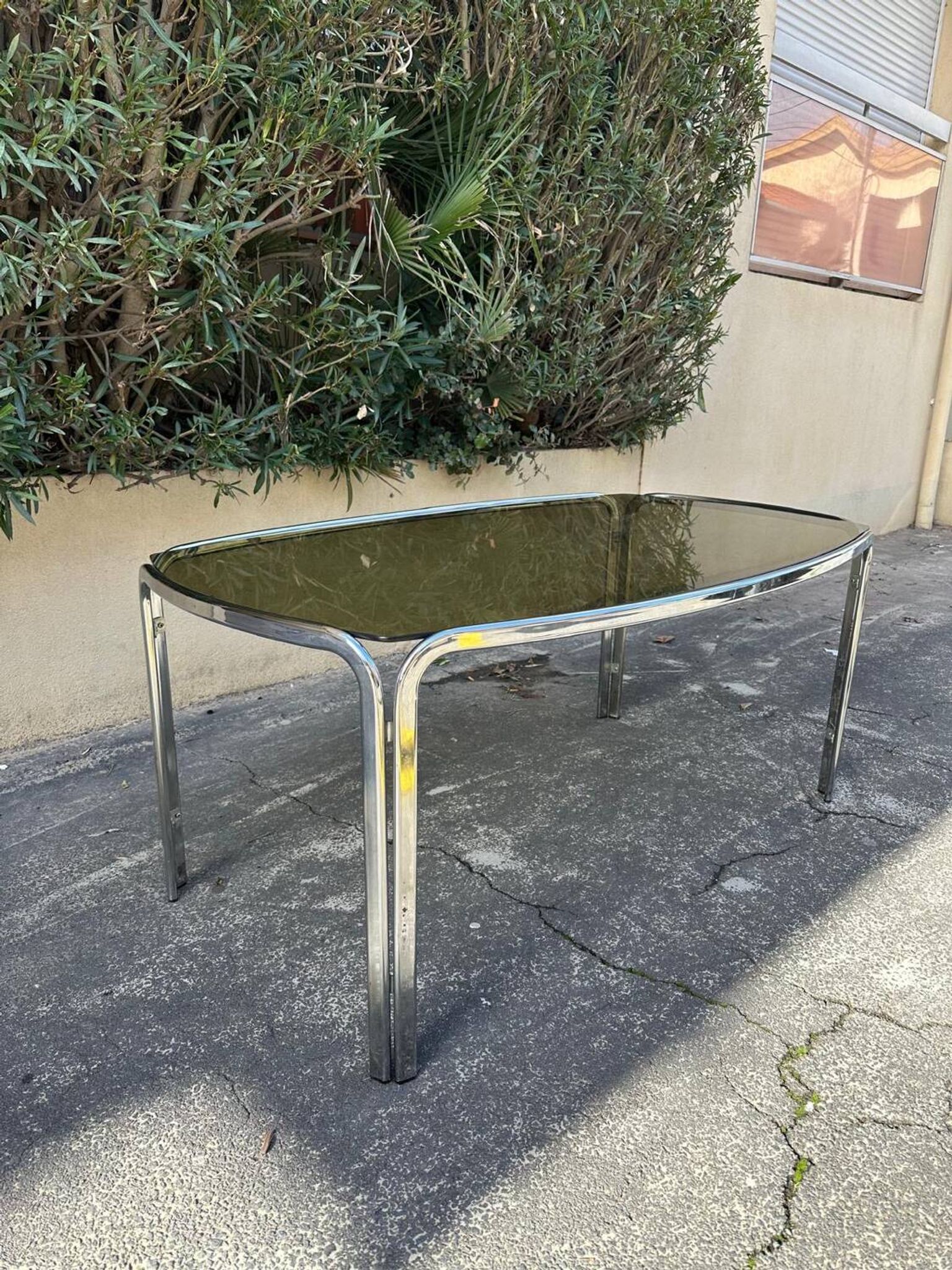 Vintage curved rectangular dining table in smoked glass and metal.