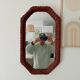 Vintage octagonal mirror in woven rattan.